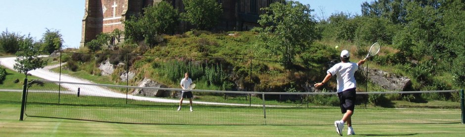 Playing tennis on the grass courts